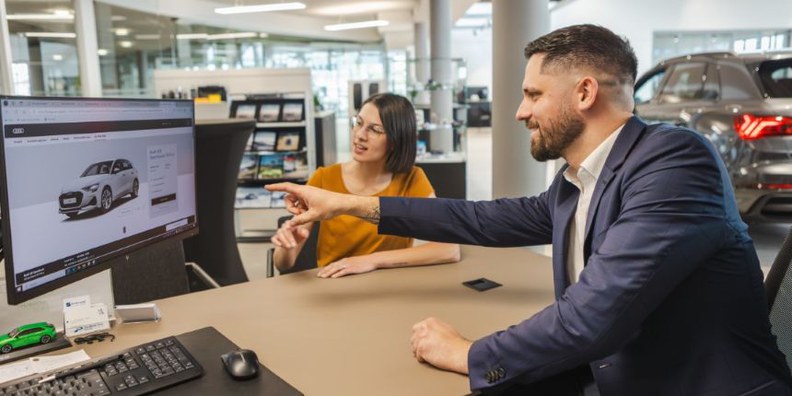 In unserem Autohaus in Amstetten-Neufurth bieten wir ab sofort eine berufliche Chance als Automobilverkäufer für die Marke VW - gleich jetzt bewerben! Am Bild: Verkäufer, welcher einer Kundin ein Fahrzeug zeigt